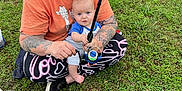 Reid joined the competition — help win amazing prizes! adult, baby, casual_clothing, child, daylight, fishing, fishing_rod, footwear, glasses, grass, greenery, leisure, nature, outdoor, parenting, person, recreation, sitting, tattoo, woman