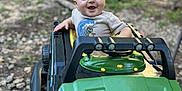 Reid joined the competition — help win amazing prizes! baby, child, cute, daylight, expression, fun, grass, green, happy, jeep, nature, outdoor, person, play, rocks, shirt, smiling, toddler, toy_car, vehicle