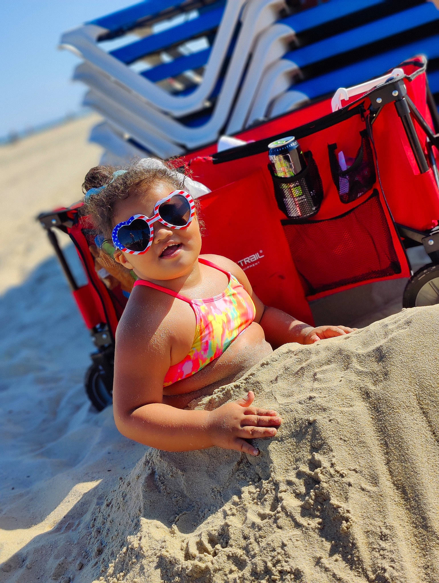 Marleigh is registered to the contest to win money with this photo: beach, blue, eyewear, fun, glasses, goggles, happy, landscape, leisure, people_in_nature, people_on_beach, person, recreation, sand, sky, summer, sun_tanning, sunglasses, thigh, travel