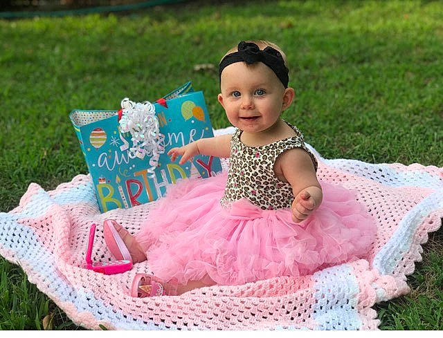 Rae'Lynn is registered to the contest to win money with this photo: baby_products, child, girl, hair_accessory, infant, joy, pattern, person, pink, play, product, textile, toddler