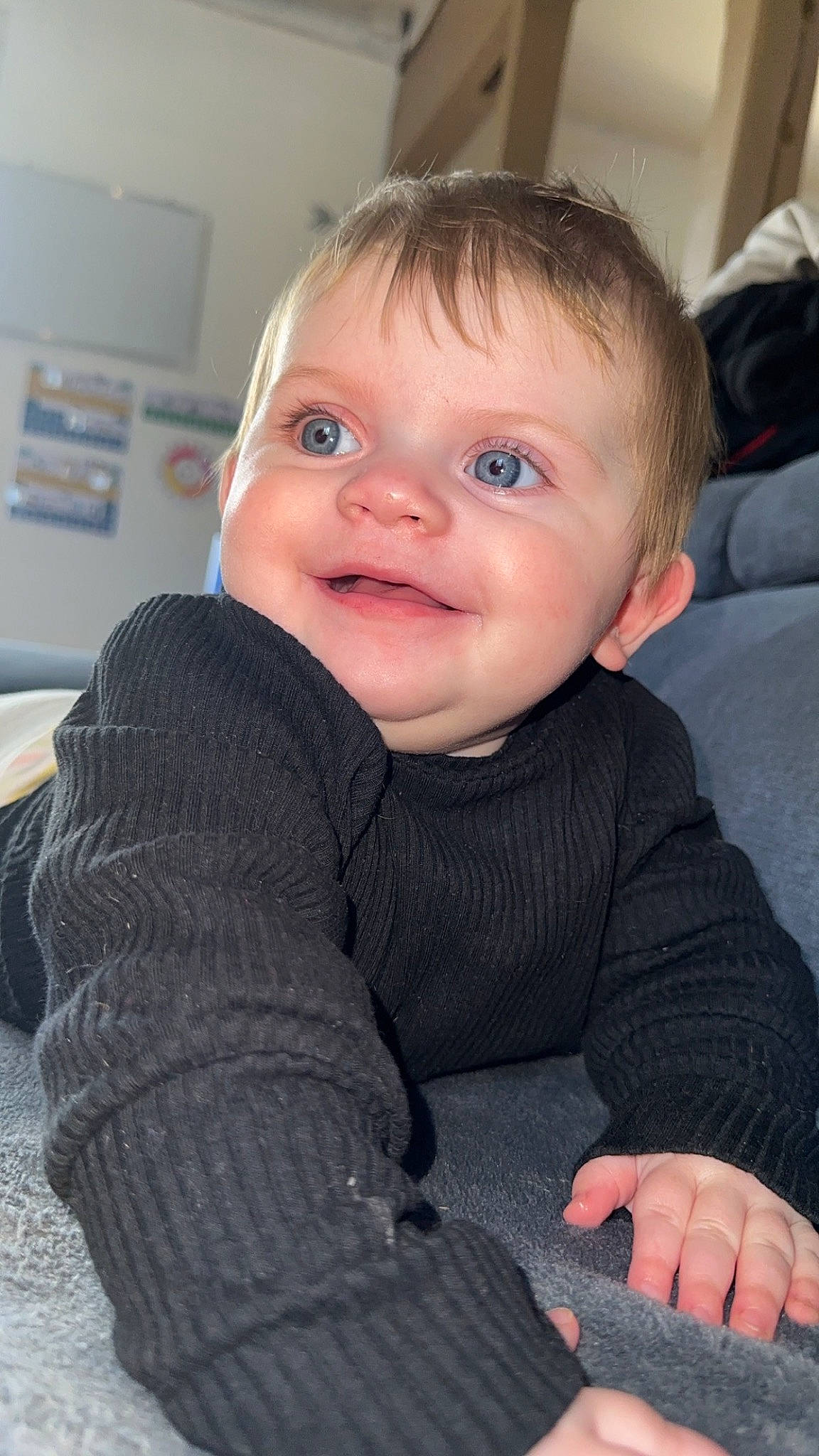 Elyana participe au concours pour gagner de l'argent avec cette photo : baby, baby_toddler_clothing, cheek, child, chin, comfort, finger, flooring, fun, happy, iris, lip, nose, person, sitting, skin, sleeve, smile, standing, thumb