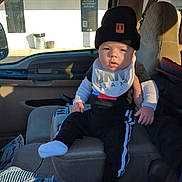 Jayden is registered to the contest to win money with this photo: baseballcap, cap, clothing, coat, cushion, face, footwear, hat, head, homedecor, hosiery, jacket, jeans, pants, person, photography, portrait, shoe, sitting, sock