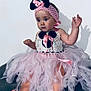 baby, child, tutu, pink, crochet, headband, ribbon, mouse_ears, dress, sitting, barefoot, curious, indoor, portrait, cute, infant, cushion, soft_toys, person, fashion