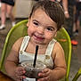 Mateo joined the competition — help win amazing prizes! toddler, child, smile, drink, iced_beverage, chair, white_clothing, cafe, happy, portrait, indoor, cute, person, hair, skin, table, holding, beverage, black_straw, buttoned_overalls