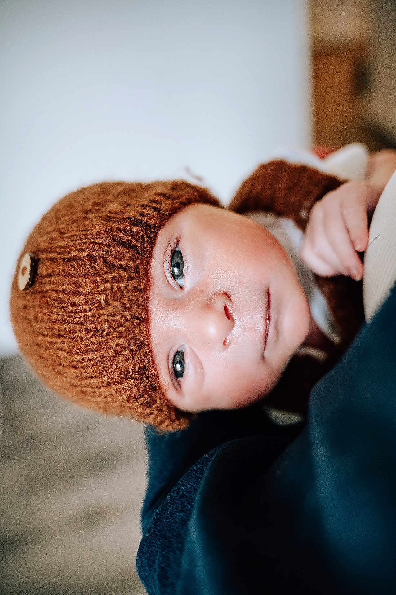 Jackson joined the competition — help win amazing prizes! baby, child, face, headwear, knit_hat, button, blue_eyes, skin, closeup, portrait, warm_colors, soft_texture, hand, clothing, indoors, infant, cute, young, expression, looking