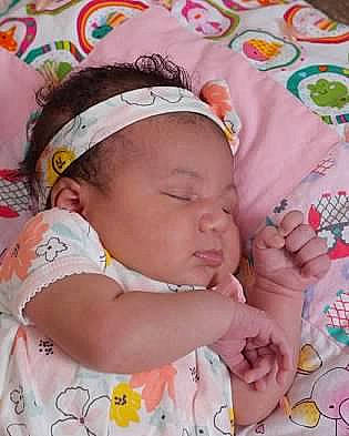 Lovee is registered to the contest to win money with this photo: baby, baby_products, baby_toddler_clothing, cap, cheek, child, face, finger, head, headgear, linens, lip, nail, nose, pattern, person, pink, product, skin, textile