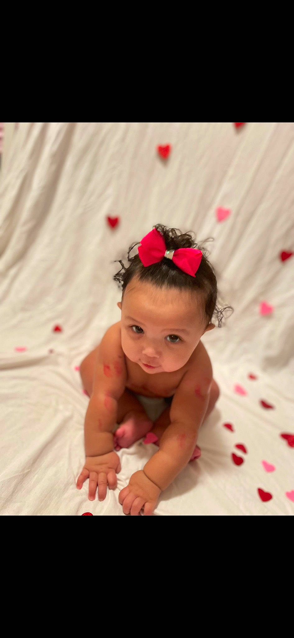 Malani is registered to the contest to win money with this photo: baby, baby_toddler_clothing, chest, child, comfort, fashion_accessory, flash_photography, flooring, foot, fun, happy, headband, human_leg, linens, magenta, person, petal, pink, portrait_photography, smile