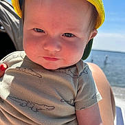Hardin joined the competition — help win amazing prizes! baby, child, yellow_cap, crocodile_print, onesie, outdoor, sunlight, water, lake, blue_sky, person, cute, face, infant, smile, summer, nature, portrait, hand, skin