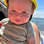 baby, child, yellow_cap, crocodile_print, onesie, outdoor, sunlight, water, lake, blue_sky, person, cute, face, infant, smile, summer, nature, portrait, hand, skin
