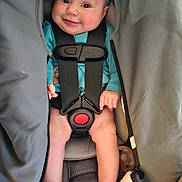 Violet is registered to the contest to win money with this photo: baby, infant, car_seat, smile, child, headband, clothing, safety_harness, cute, happy, person, seat, blanket, small_child, legs, portrait, indoors, comfort, baby_toys, pacifier