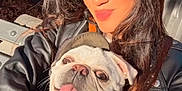 Gypsy joined the competition — help win amazing prizes! woman, dog, pug, smiling, selfie, outdoor, bench, leather_jacket, sunlight, happy, pet, tongue_out, face, long_hair, casual, daylight, portrait, cute, animal, person