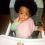 baby, child, high_chair, bib, food, afro, curly_hair, indoor, feeding, tray, cute, smiling, person, infant, clothing, hand, table, face, young_child, seat