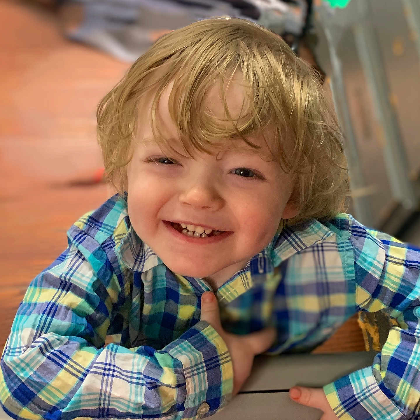 Asher is registered to the contest to win money with this photo: blonde_hair, bright_colors, candid, casual_clothing, cheerful, child, close_up, cute, expression, face, happy, indoor, joyful, leaning, person, plaid_shirt, portrait, smiling, toddler, young_child