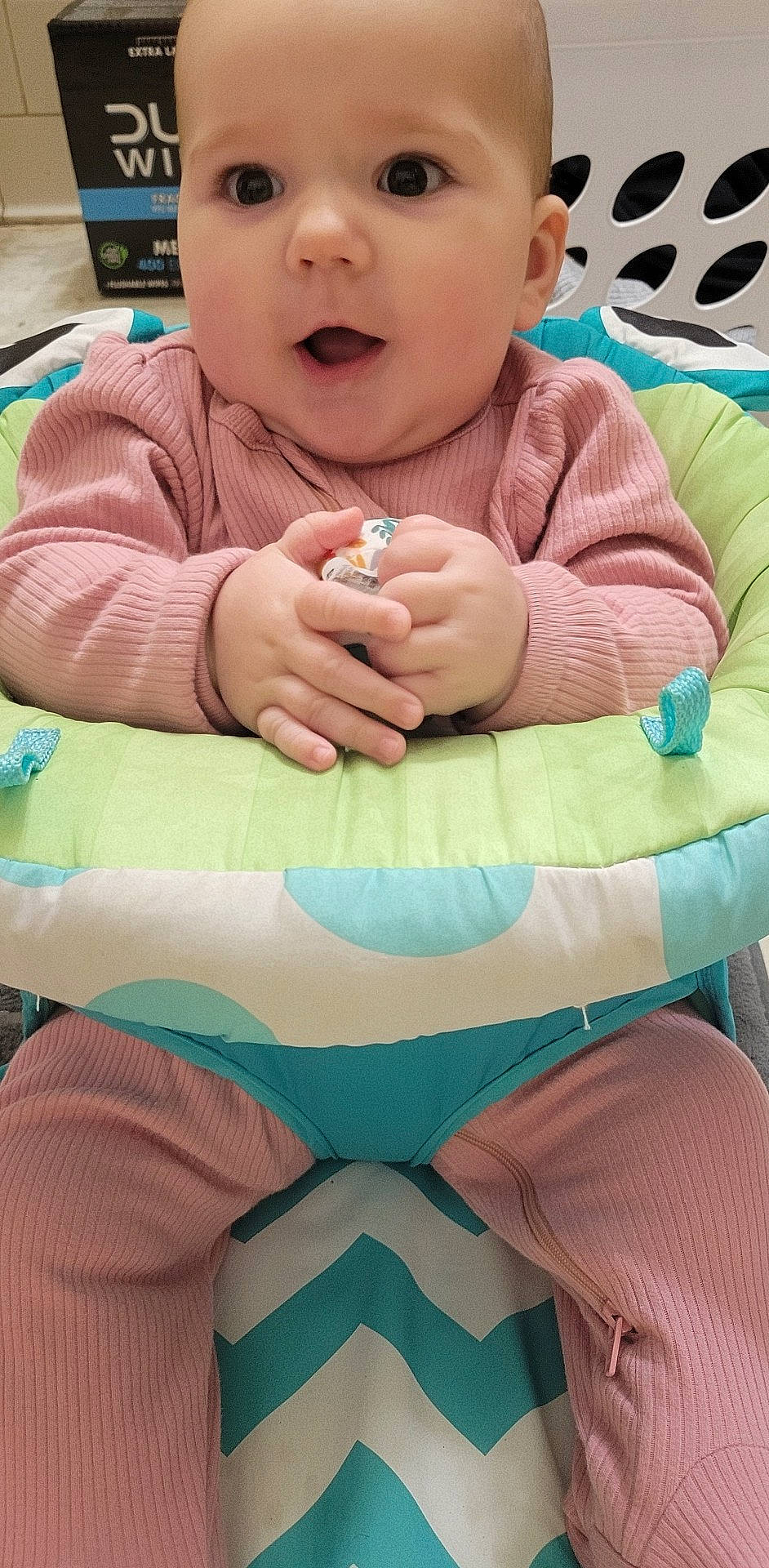 Lorelai joined the competition — help win amazing prizes! baby, baby_toddler_clothing, blue, cheek, comfort, face, finger, gesture, green, hand, happy, mouth, person, pink, skin, sleeve, surprise, textile, thumb, toddler