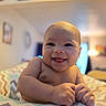 Elyzah is registered to the contest to win money with this photo: baby, smiling, infant, face, skin, hands, blanket, zigzag_pattern, indoor, home, cozy, happy, cute, child, portrait, closeup, newborn, person, warm_light, soft_focus
