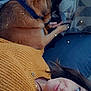 woman, dog, couch, blanket, pillow, sweater, cozy, indoor, relaxing, sleeping_dog, lying_down, casual, brown_hair, knitwear, companion, pets, comfort, portrait, stars_filter, home