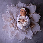 Mia participe au concours pour gagner de l'argent avec cette photo : baby, infant, flower, white, headband, knitwear, wrapped, soft, portrait, studio, cute, newborn, peaceful, decorative, props, child, face, hands, feet, sleepwear