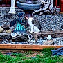 animal, cat, closeup, curious, daylight, decor, fairy_statue, garden, grass, nature, outdoor, pebbles, pet, quiet, sitting, small_animal, statue, stones, tabby_cat, wood