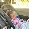 Ahvi joined the competition — help win amazing prizes! baby, infant, sleeping, car_seat, vehicle, travel, passenger, blanket, pink_bib, pacifier_clip, portrait, indoors, sunlight, window, road_trip, child, resting,  안전, safety_straps, daytime