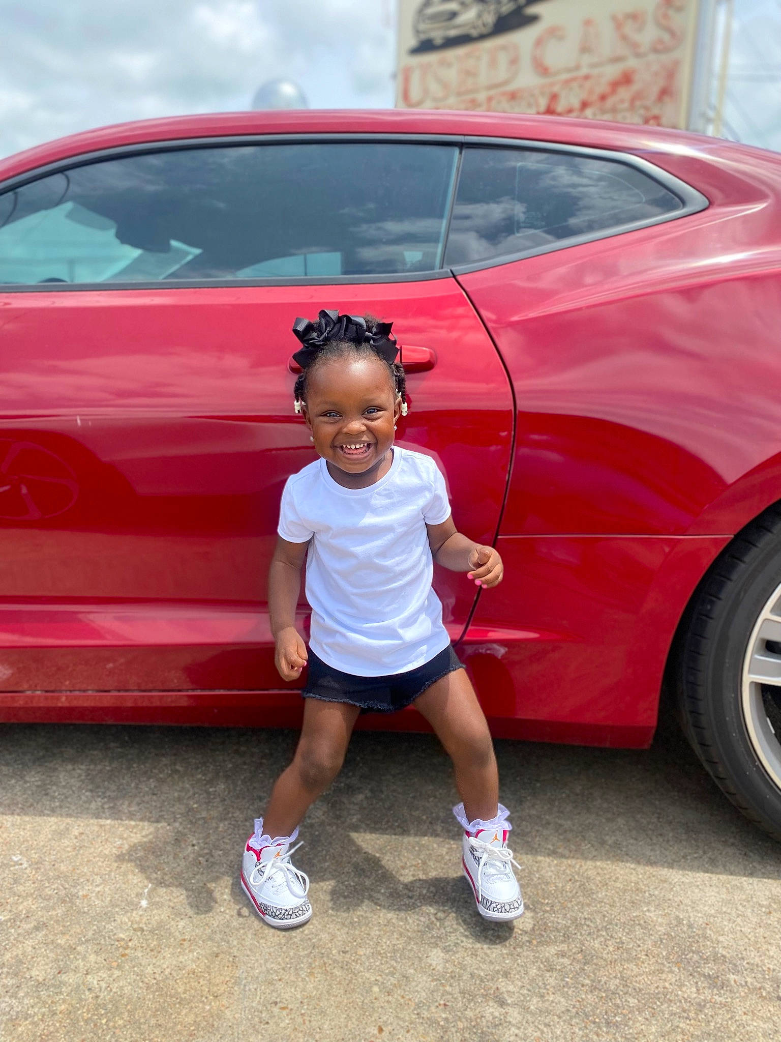 Kaydence joined the competition — help win amazing prizes! alloy_wheel, automotive_design, automotive_exterior, automotive_lighting, automotive_tire, blue, bumper, car, footwear, hood, joy, land_vehicle, motor_vehicle, person, pink, red, shorts, smile, tire, vehicle