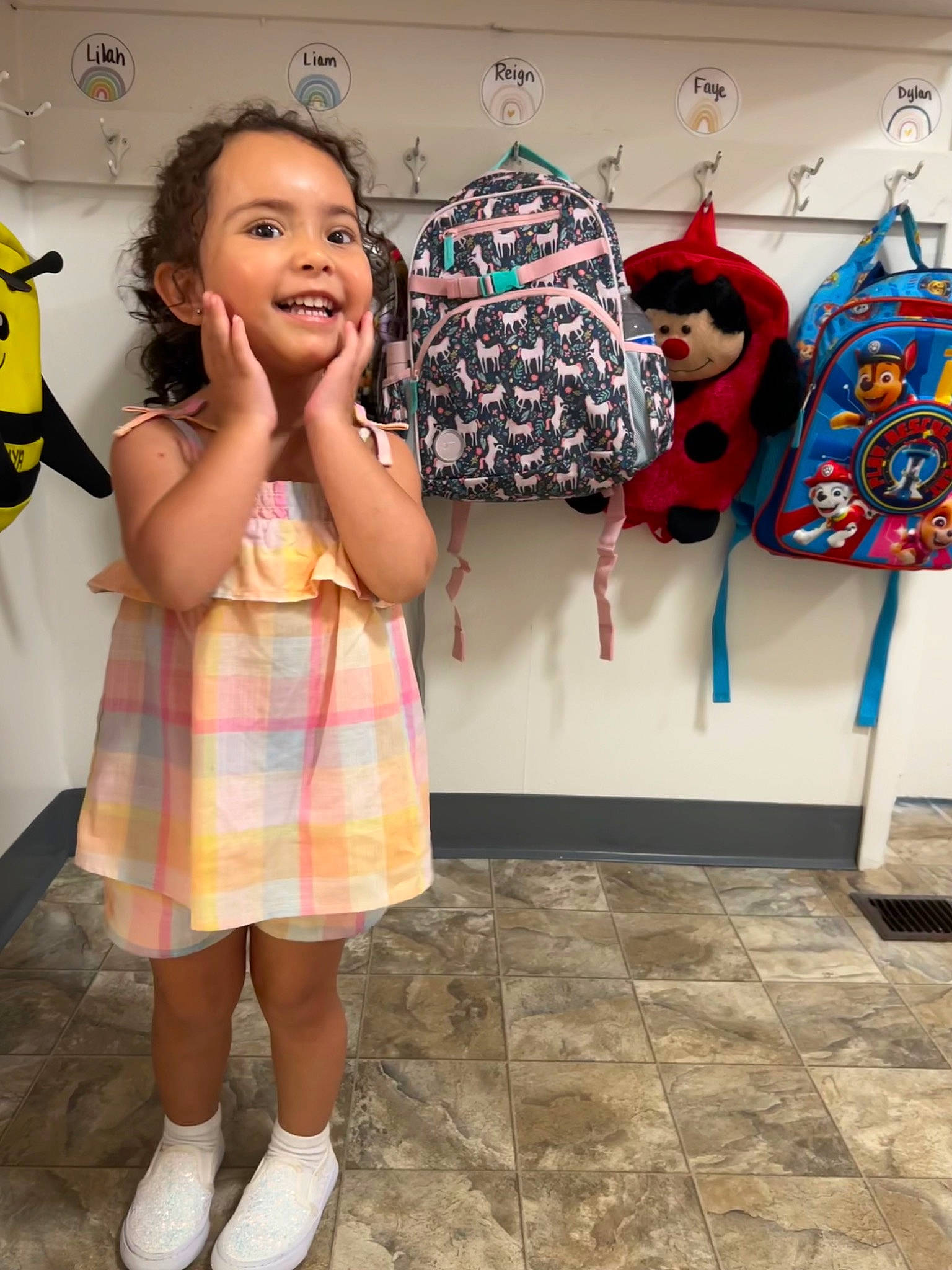 Reign is registered to the contest to win money with this photo: child, event, fashion, fashion_design, flooring, fun, happy, human_leg, joy, pattern, person, plaid, room, sandal, shoe, smile, sock, standing, textile, toddler