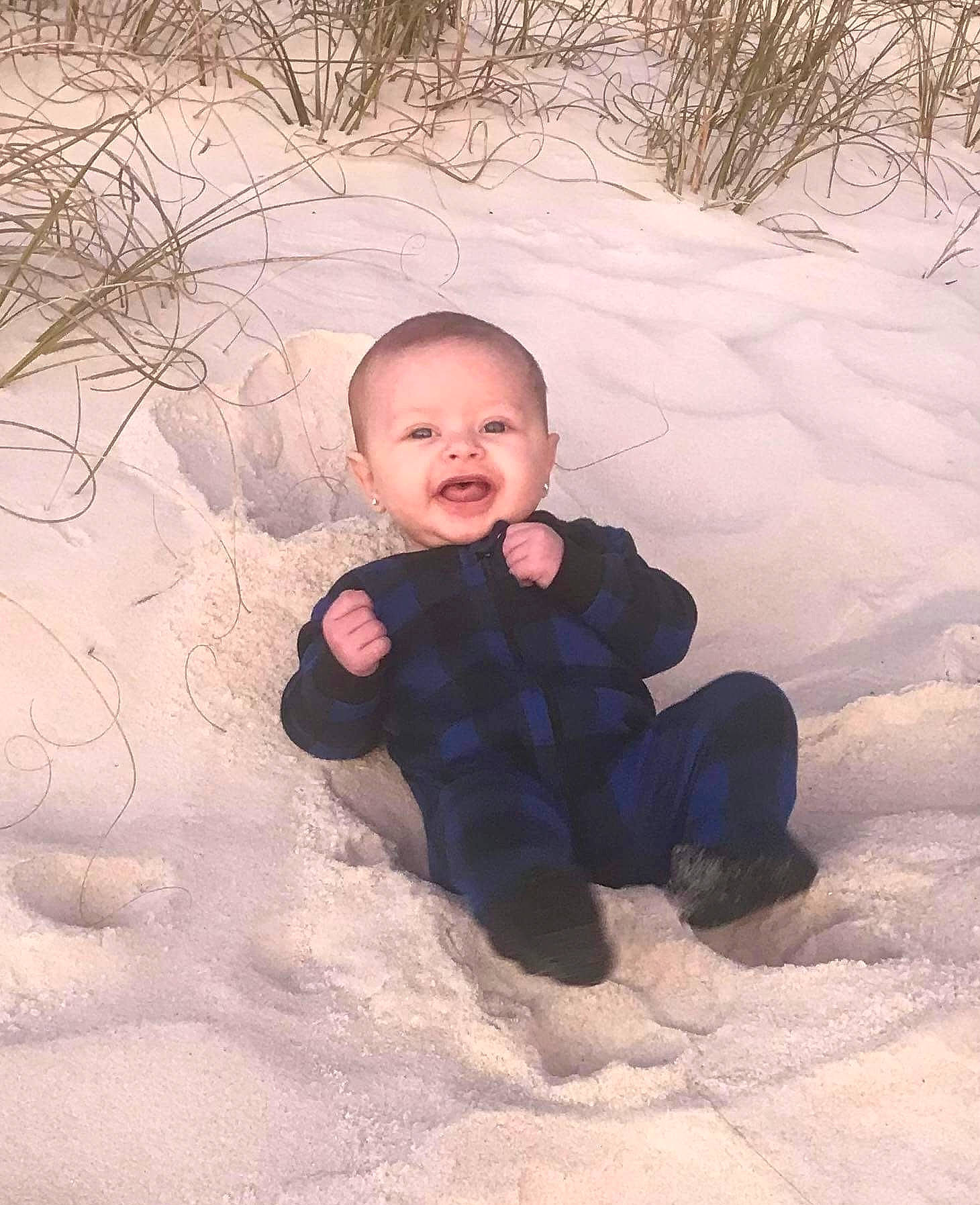 Raeleigh is registered to the contest to win money with this photo: baby, baby_toddler_clothing, cheek, face, flash_photography, freezing, fun, grass, happy, head, people_in_nature, person, playing_with_kids, recreation, smile, snow, tints_and_shades, toddler, tree, wilderness
