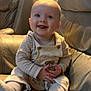 Mikey-Rhys joined the competition — help win amazing prizes! baby, child, clothing, couch, cute, face, hands, happy, head, indoors, infant, leather, overalls, portrait, sitting, skin, smiling, socks, toddler, warm_light