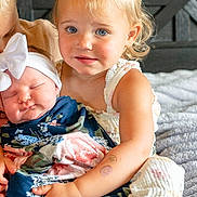 Callaway is registered to the contest to win money with this photo: baby, bed, blanket, blue, bow, child, cute, family, floral_pattern, hair, headboard, holding, indoor, love, pink, portrait, skin, sleeping, toddler, white