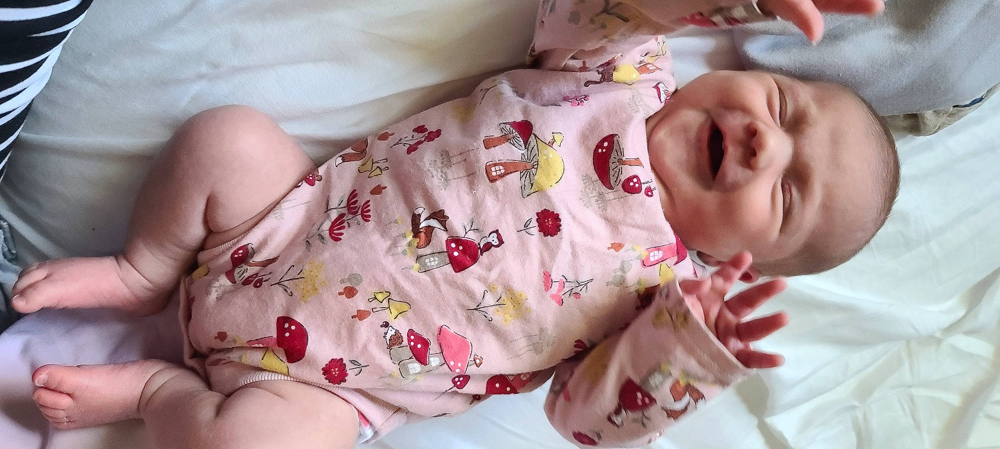 Emery is registered to the contest to win money with this photo: arm, baby_toddler_clothing, cheek, comfort, dress, face, finger, hand, head, human_body, lip, mouth, muscle, neck, nose, person, pink, skin, sleeve, textile