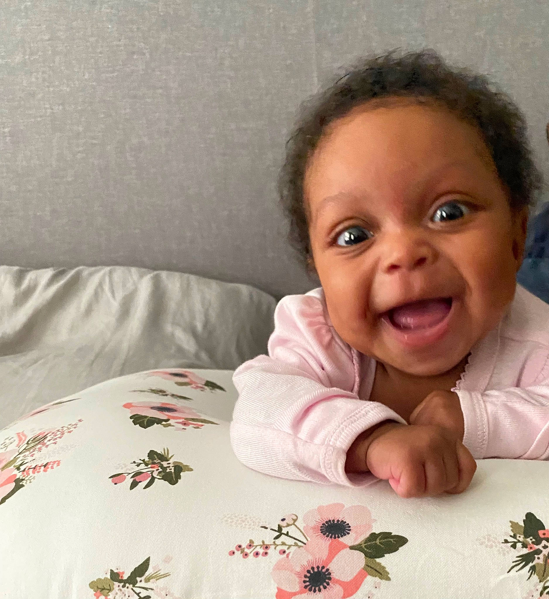 Adora is registered to the contest to win money with this photo: baby, baby_toddler_clothing, bed, bedding, comfort, eye, finger, flower, hand, happy, head, linens, pattern, person, petal, plant, sleeve, smile, textile, toddler