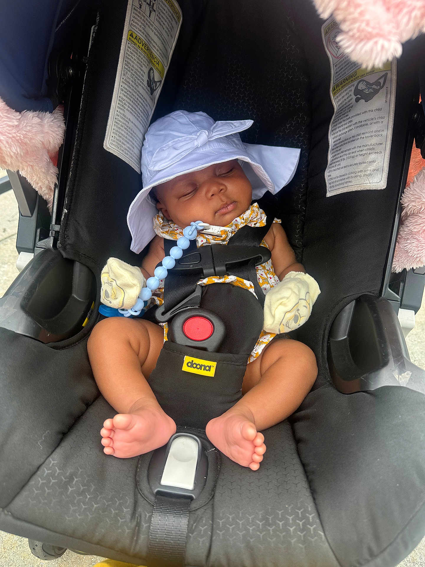 A'Jshanae is registered to the contest to win money with this photo: baby, sleeping, car_seat, doona, hat, mittens, infant, child, footwear, toy, black, white, comfort, seatbelt, cute, peaceful, outdoor, sun_hat, safety, plush