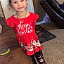 Arabella is registered to the contest to win money with this photo: child, girl, smiling, red_dress, christmas_theme, bow, curly_hair, leggings, socks, living_room, couch, carpet, door, wall, holiday, festive_clothing, happy, portrait, indoor, person