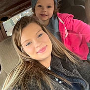 Arabella joined the competition — help win amazing prizes! child, toddler, woman, selfie, car_interior, smile, beanie, jacket, pink_clothing, fuzzy_jacket, happy, portrait, closeup, casual, indoor, seat, window, curly_hair, long_hair, people