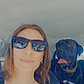 black_dog, car, casual, collar, companion, dog, friendship, happy, indoor, leisure, pet, portrait, seatbelt, selfie, smile, summer, sunglasses, tongue_out, vehicle, woman