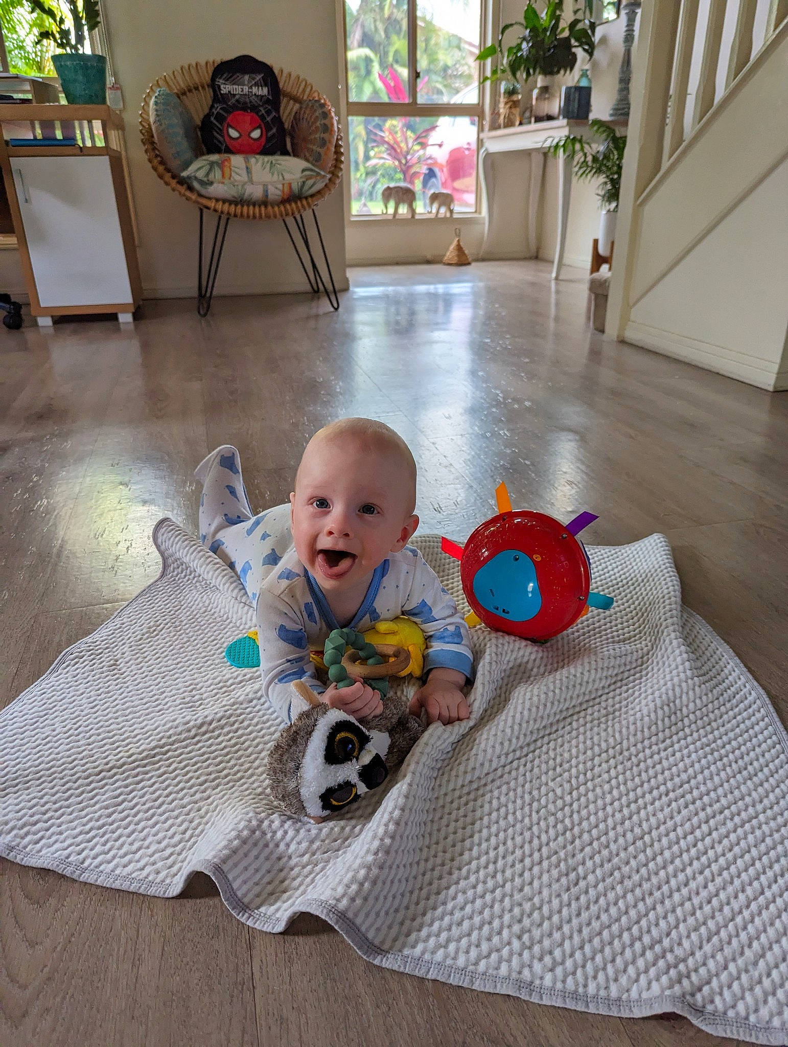 Bodhi is registered to the contest to win money with this photo: baby, baby_toddler_clothing, carpet, chair, child, comfort, floor, flooring, fun, green, hardwood, houseplant, leisure, person, plant, room, sitting, smile, surprise, toddler