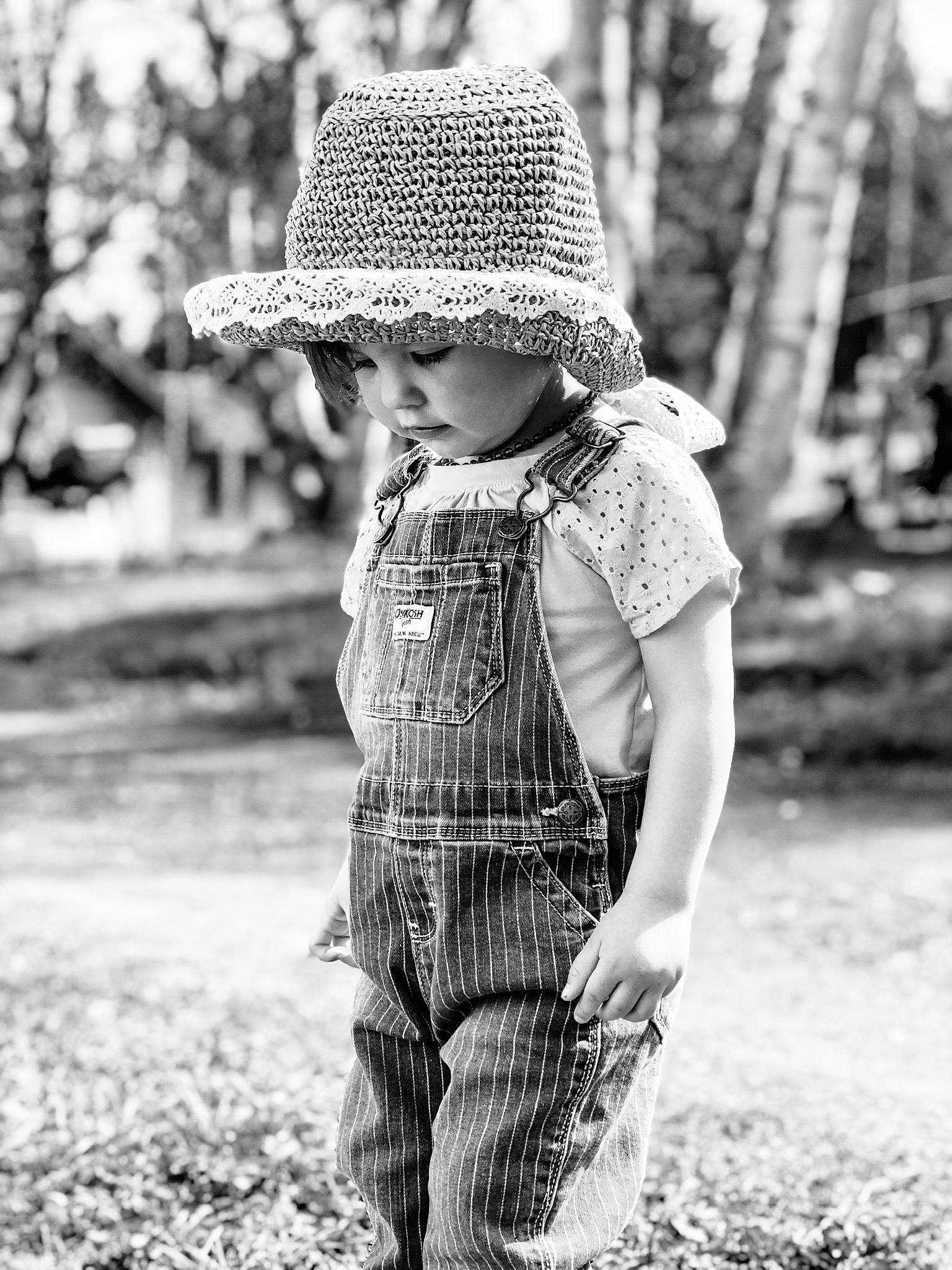 Emilyn joined the competition — help win amazing prizes! black, black_and_white, cap, clothing, grass, happy, hat, headgear, headwear, human, human_body, leaf, people_in_nature, person, plant, smile, standing, style, sun_hat, tree
