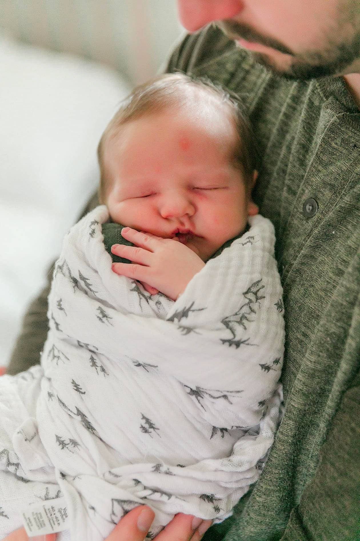 Landon is registered to the contest to win money with this photo: baby, baby_products, baby_sleeping, baby_toddler_clothing, beard, bedtime, cheek, child, comfort, event, eye, facial_expression, grass, happy, interaction, linens, nose, person, skin, sleeve