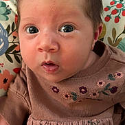 Aurora joined the competition — help win amazing prizes! baby, infant, face, expression, clothing, dress, embroidery, floral, cushion, pattern, colorful, skin, eyes, hair, mouth, cute, indoors, portrait, child, person