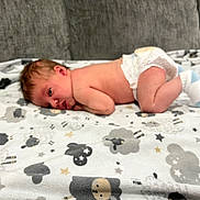 Luka joined the competition — help win amazing prizes! baby, infant, diaper, blanket, pattern, sheep, stars, socks, couch, soft, lying_down, curious, skin, indoors, newborn, child, cute, resting, cozy, comfort