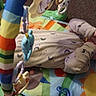 Benjamin joined the competition — help win amazing prizes! baby, infant, play_mat, onesie, baby_toys, colorful, floor, carpet, child, cute, indoors, face, sucking_thumb, lying_down, soft_toys, patterned_clothing, young_child, baby_play, closeup, comfort