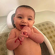 Luka joined the competition — help win amazing prizes! baby, bare_chested, bath_seat, bathroom, bathtub, candid, child, close_up, fingers, hands, happy, indoor, infant, patterned_surface, portrait, sitting, smiling, water_droplets, wet, white