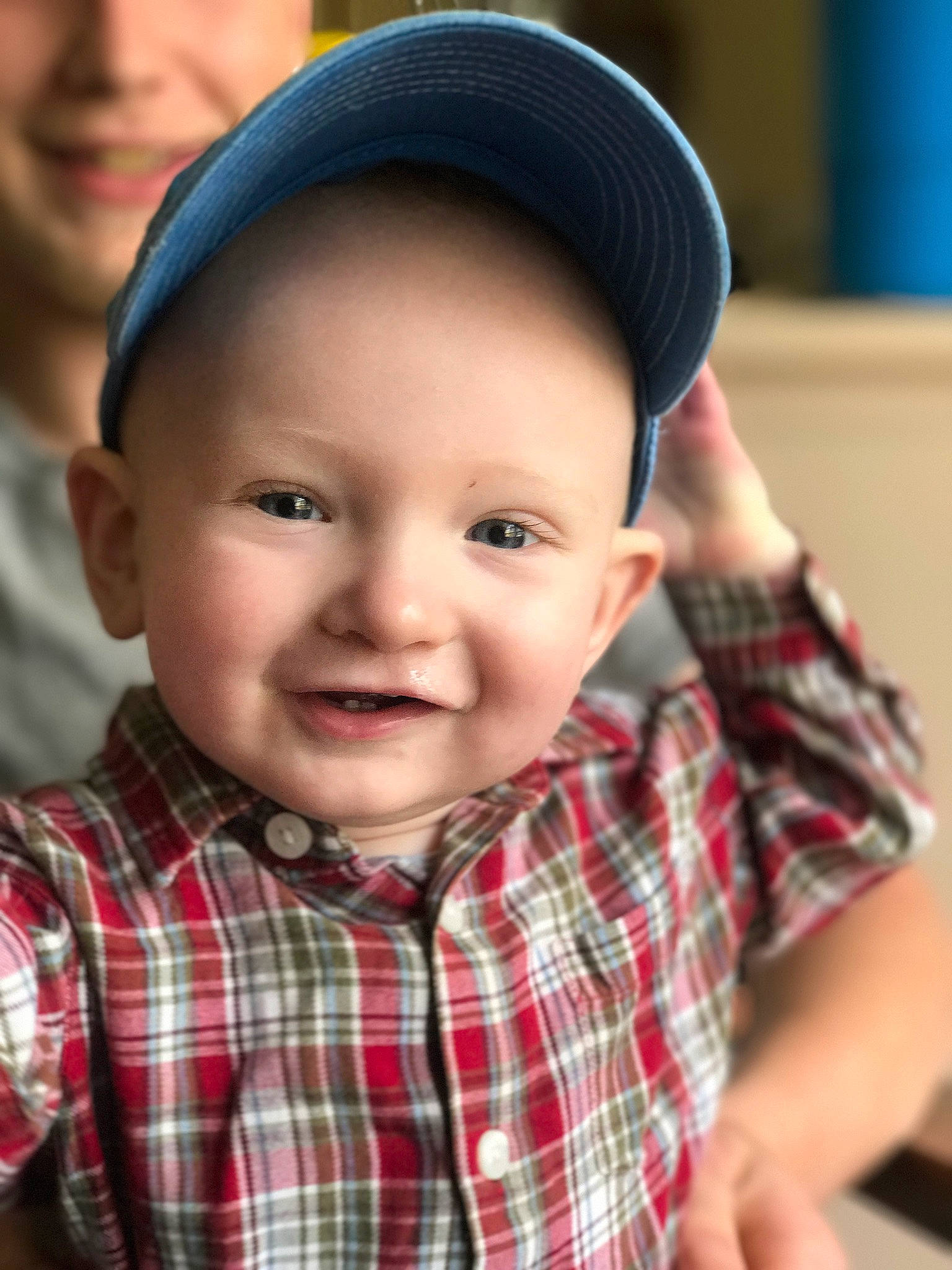 Maddix is registered to the contest to win money with this photo: baby, cap, cheek, child, chin, design, face, facial_expression, fashion_accessory, fun, happy, hat, head, headgear, joy, nose, pattern, person, plaid, skin