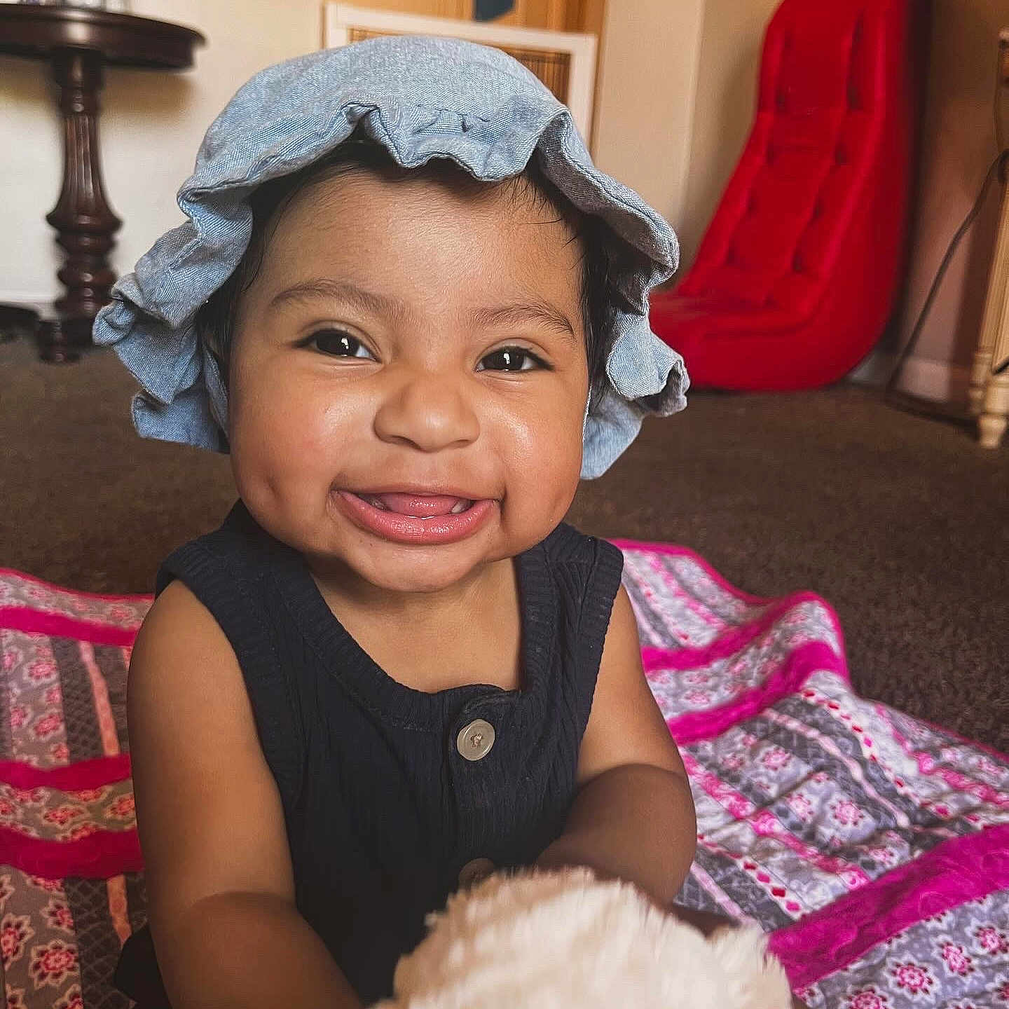 Rosalina is registered to the contest to win money with this photo: baby, babylaughing, bonnet, cap, clothing, couch, cushion, dimples, face, furniture, happy, hat, head, homedecor, person, photography, portrait, sitting, sleeve, smile