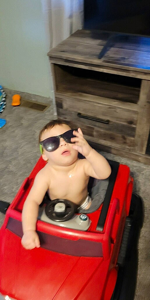 Thiago joined the competition — help win amazing prizes! arm, baby, baby_products, chest, child, eyewear, flooring, fun, goggles, leisure, person, personal_protective_equipment, recreation, room, sitting, sunglasses, thigh, toddler, toy, toy_vehicle