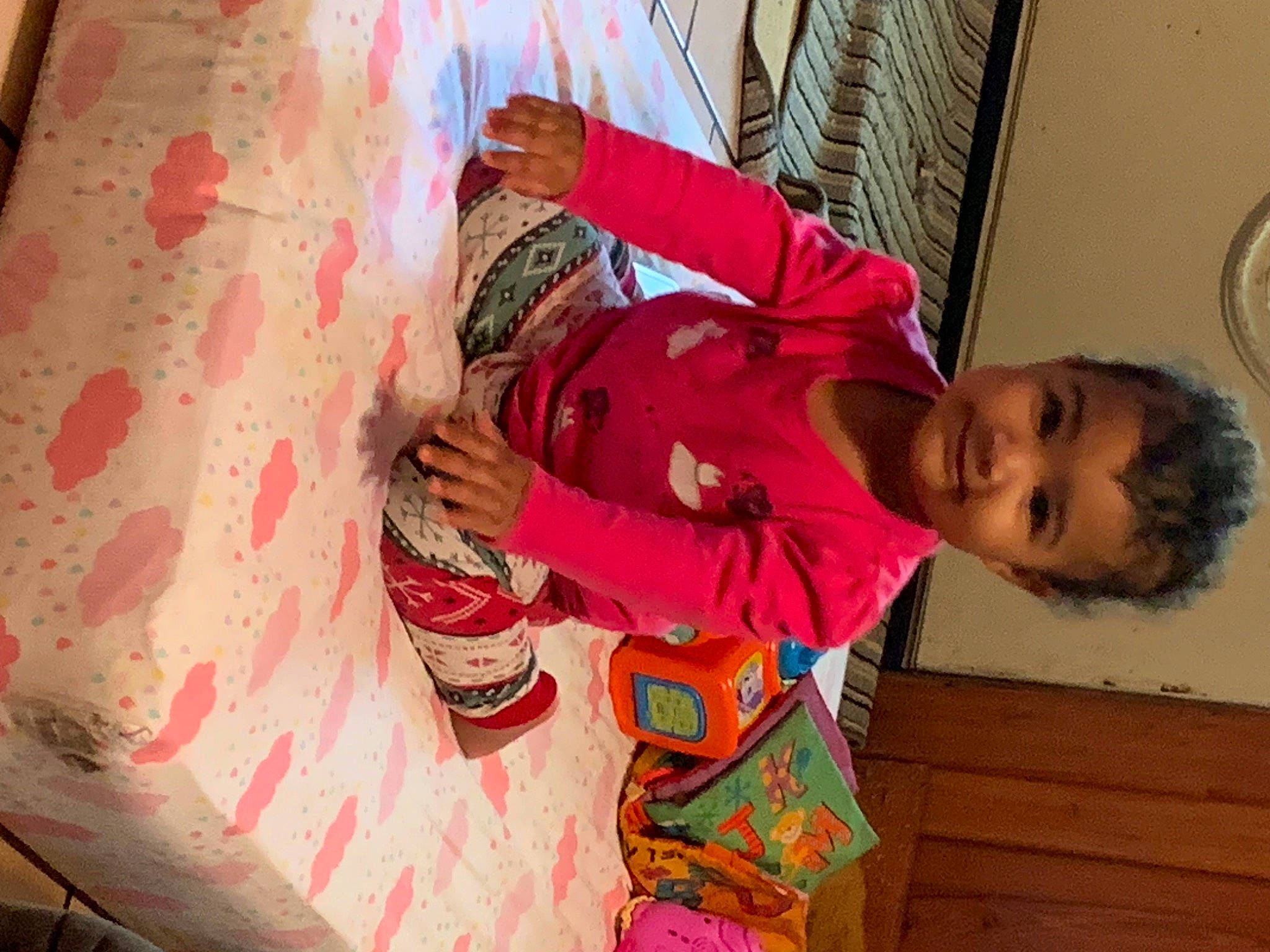 Amelia is registered to the contest to win money with this photo: baby_toddler_clothing, child, clock, eye, flooring, fun, happy, head, human_body, joy, leg, leisure, magenta, pattern, person, pink, room, smile, temple, toddler