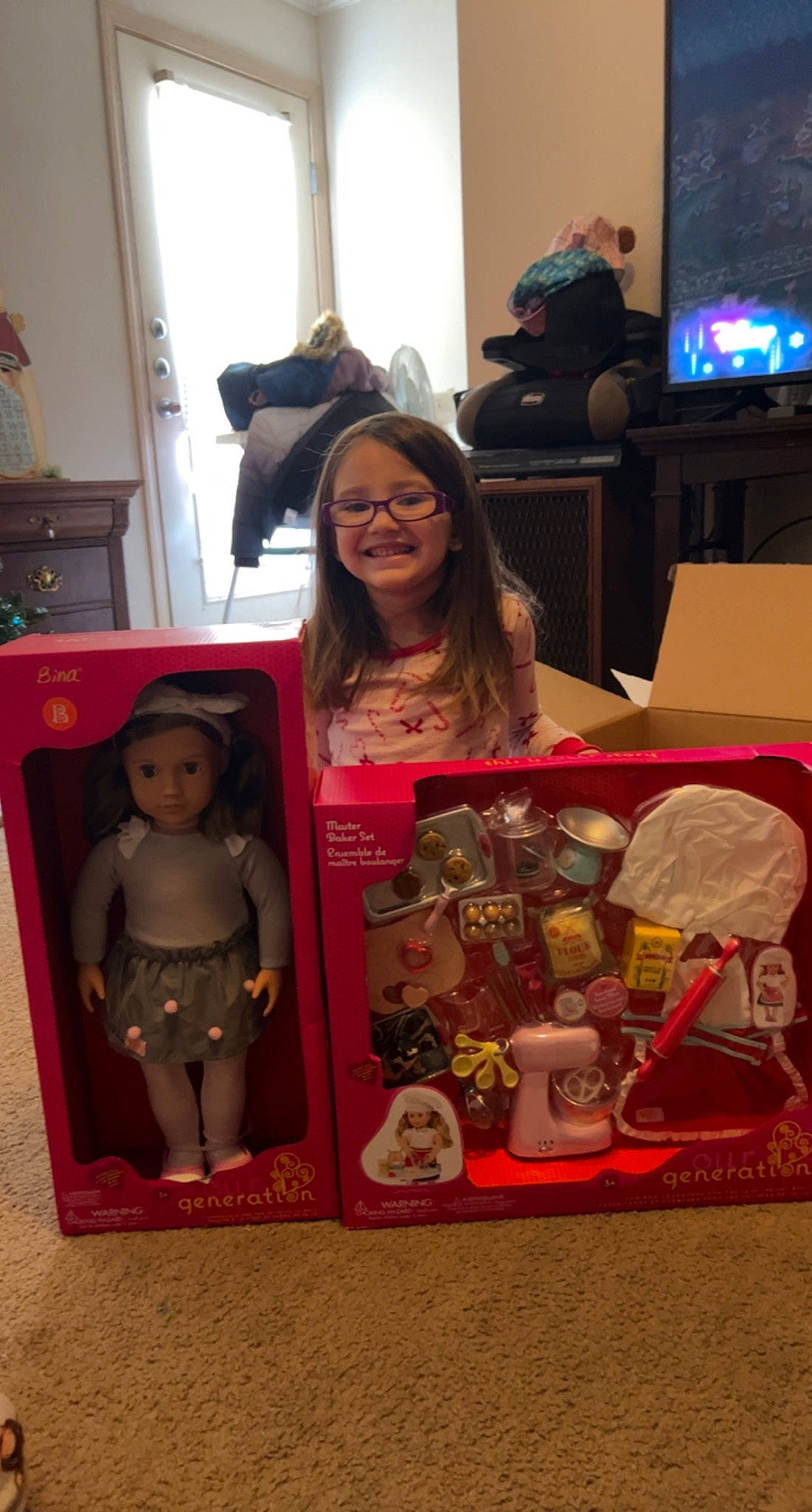 Emma is registered to the contest to win money with this photo: animation, art, child, collection, costume, curtain, display_device, doll, electronic_device, event, eyewear, fictional_character, flooring, fun, joy, led_backlit_lcd_display, person, room, smile, stuffed_toy