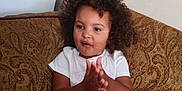 Myrtlelee joined the competition — help win amazing prizes! casual_clothing, child, clapping, comfortable, couch, curly_hair, cute, expression, face, home, indoor, legs, patterned_fabric, person, pink_shorts, sitting, skin, toddler, white_shirt, young