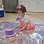 Riley joined the competition — help win amazing prizes! toddler, child, cake, birthday, kitchen, floor, pink_bow, tutu, purple_cake, holographic_mat, curious, messy, indoor, tile_floor, young_child, celebration, headband, sitting, playful, food