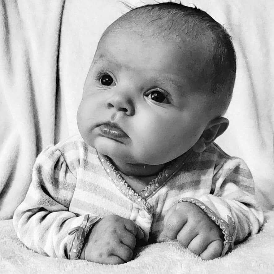 Brianna is registered to the contest to win money with this photo: arm, baby, baby_toddler_clothing, black, black_and_white, cheek, comfort, ear, eyebrow, finger, flash_photography, gesture, hand, happy, iris, lip, nose, person, skin, sleeve