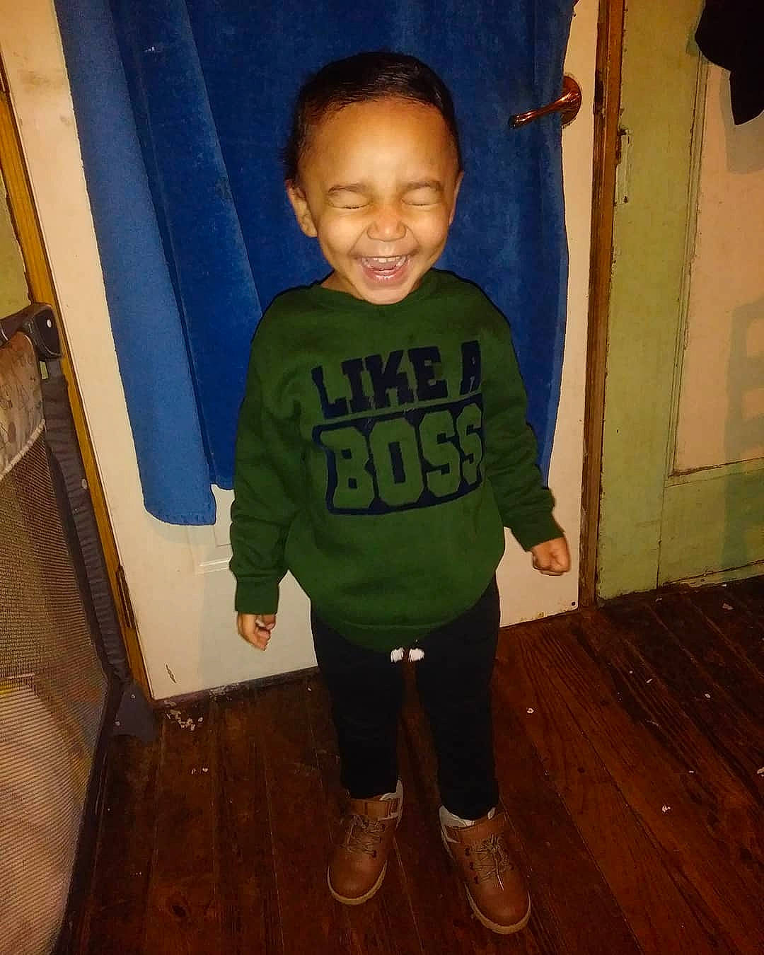 Alexander is registered to the contest to win money with this photo: arm, boy, child, clothing, cool, day, eye, facial_expression, fun, green, human, joy, organ, outerwear, person, play, product, smile, snapshot, standing